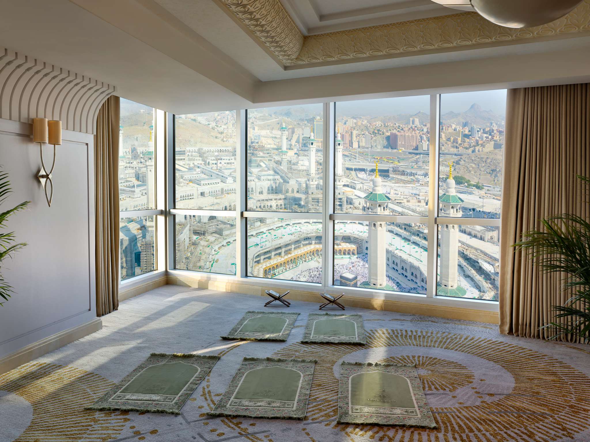 Three generations of a family in a Clock Tower hotel suite overlooking Masjid al-Haram